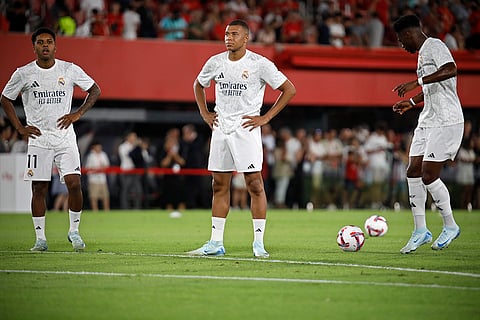 La Liga, Real Madrid vs Mallorca: Kylian Mbappe, centre, stands with Real Madrid's Rodrygo, left and Aurelien Tchouameni
